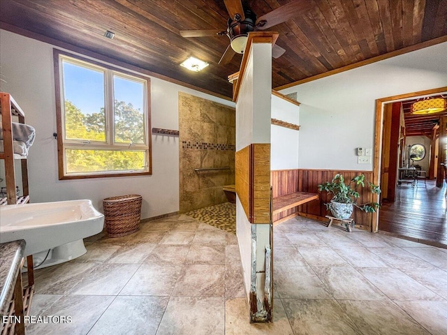 bathroom with wood ceiling, ceiling fan, and a shower