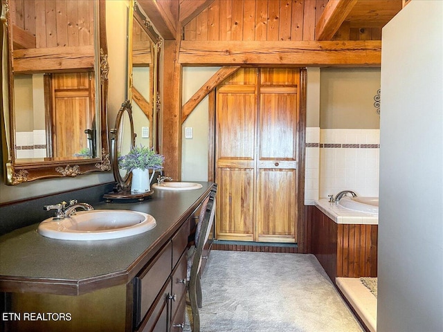 bathroom with vanity and a washtub