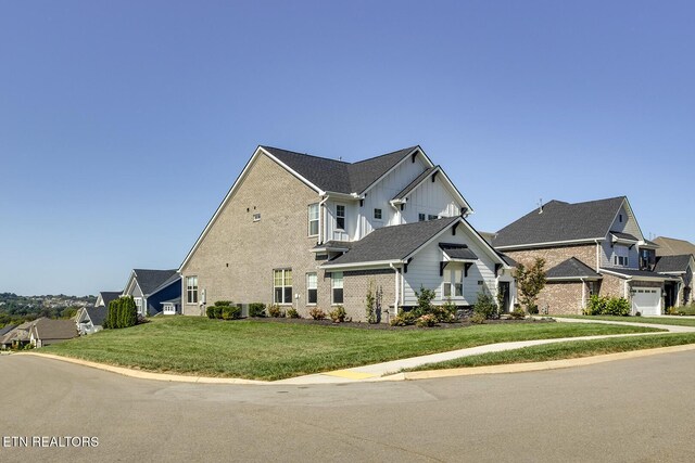 view of front of home featuring board and batten siding and a front yard