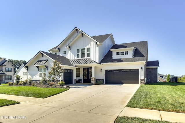 view of front of property featuring board and batten siding, concrete driveway, a front lawn, and a garage
