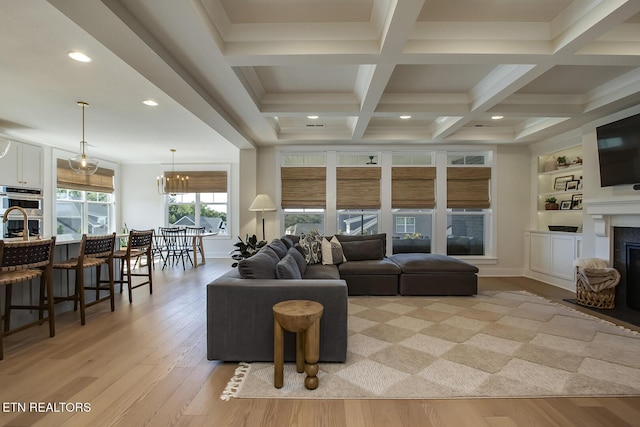 living room with light wood-type flooring, recessed lighting, a fireplace, and beamed ceiling