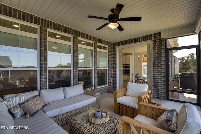 sunroom / solarium featuring ceiling fan and outdoor lounge area