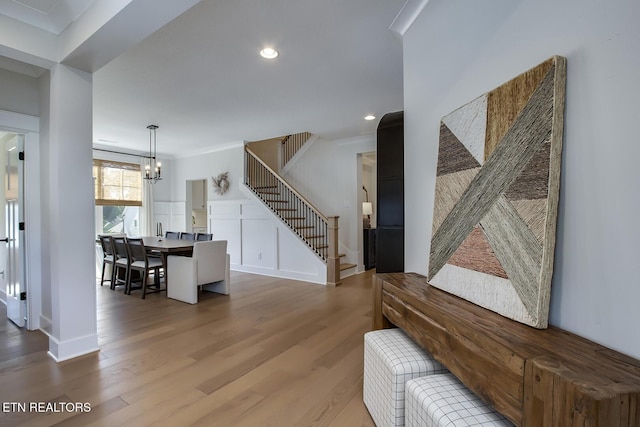 interior space with recessed lighting, stairs, wood finished floors, and a chandelier