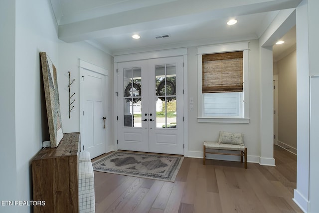 entryway featuring crown molding, visible vents, french doors, and wood finished floors