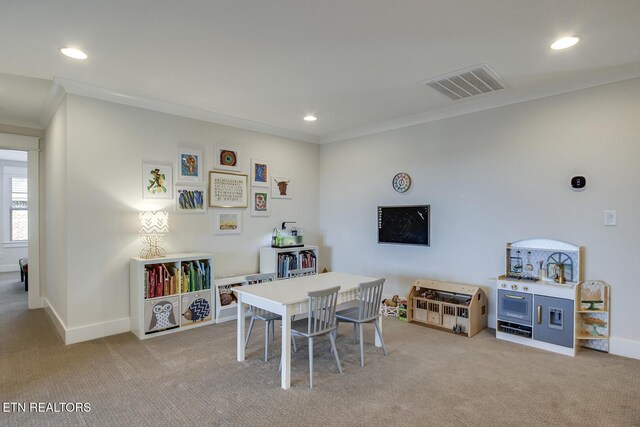 recreation room featuring crown molding, visible vents, and light carpet
