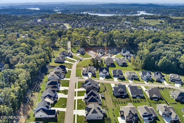 bird's eye view featuring a forest view and a residential view