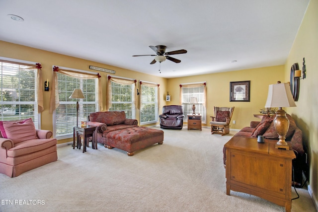 living room with ceiling fan and light colored carpet