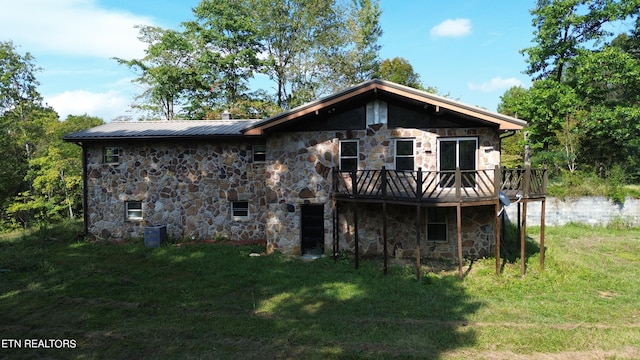 view of property exterior featuring a lawn and a deck