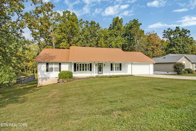 ranch-style house featuring a garage and a front lawn