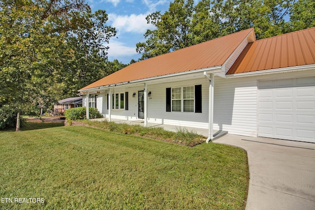 ranch-style house with a garage, a front yard, a porch, and metal roof
