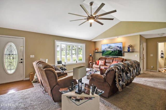 living area with carpet, baseboards, vaulted ceiling, and ceiling fan