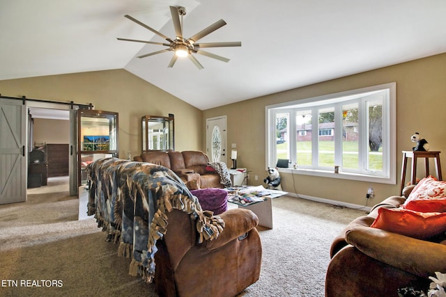 living room featuring lofted ceiling, a barn door, a ceiling fan, and carpet floors