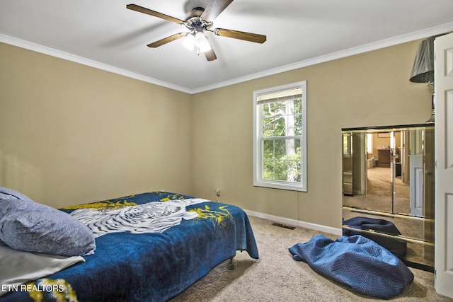 bedroom with crown molding, carpet, a ceiling fan, visible vents, and baseboards