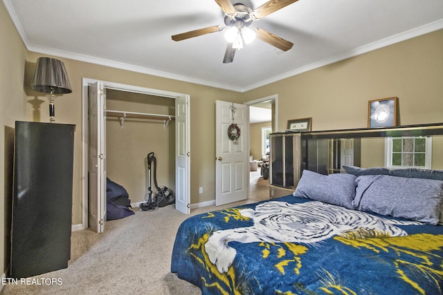 bedroom featuring ornamental molding, light carpet, ceiling fan, and a closet