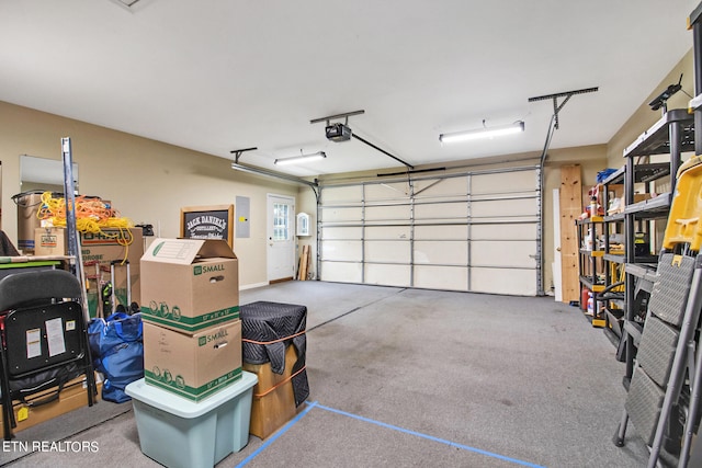 garage featuring a garage door opener and electric panel