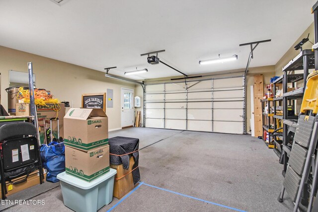 garage featuring electric panel and a garage door opener