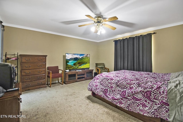 carpeted bedroom with crown molding and ceiling fan