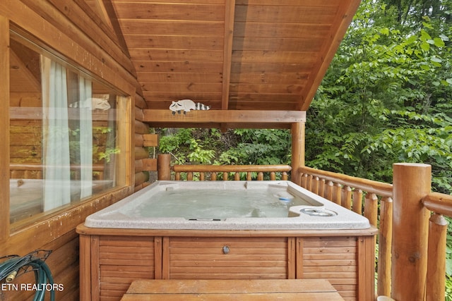 wooden deck with a hot tub