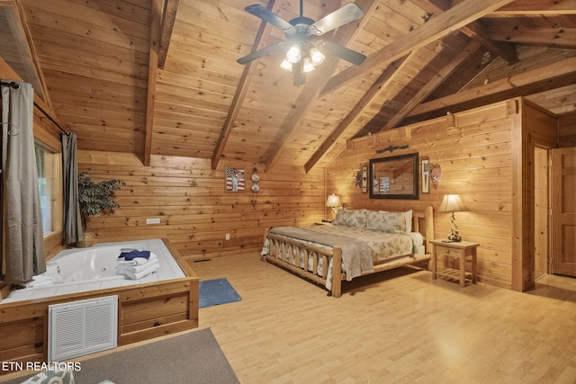 bedroom featuring wooden walls, light wood-type flooring, lofted ceiling with beams, and wooden ceiling