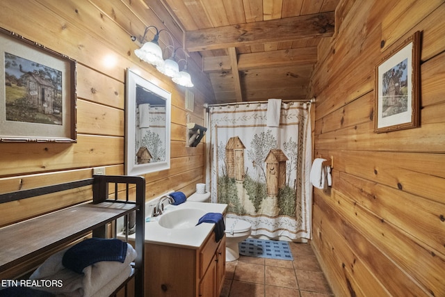 bathroom with wood ceiling, wood walls, tile patterned floors, vanity, and toilet