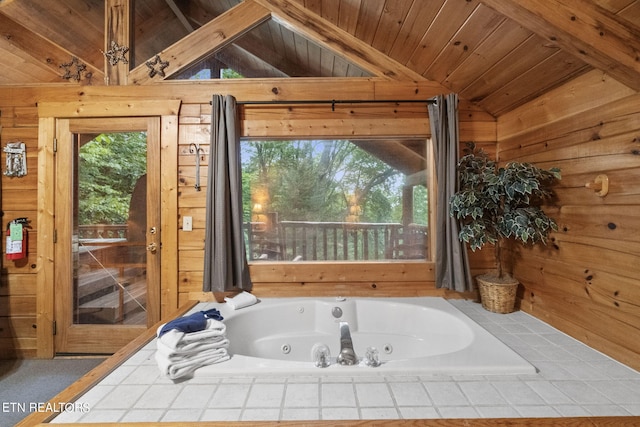 bathroom with wood ceiling, lofted ceiling with beams, and tiled tub