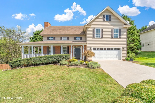 front of property featuring covered porch, a front yard, and a garage