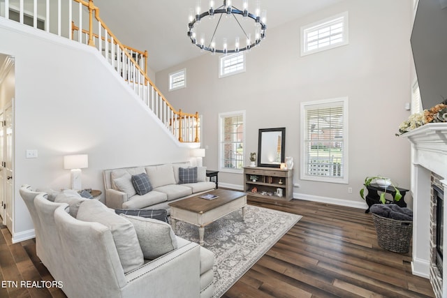 living room featuring a high ceiling and dark wood-type flooring