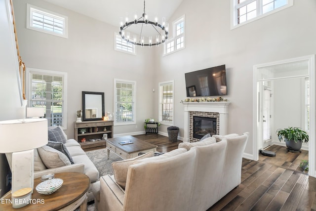 living room featuring high vaulted ceiling, a brick fireplace, plenty of natural light, and dark hardwood / wood-style flooring