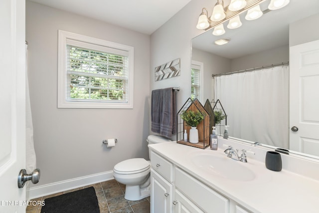 bathroom with tile patterned floors, vanity, and toilet