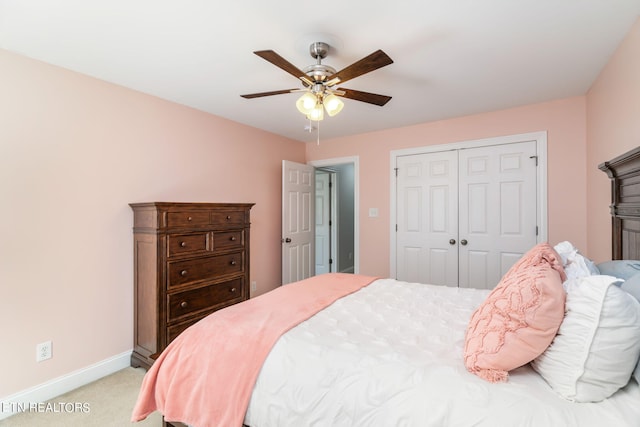 carpeted bedroom with a closet and ceiling fan