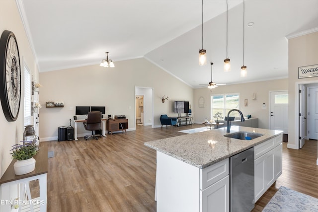 kitchen with light wood-type flooring, sink, white cabinets, vaulted ceiling, and stainless steel dishwasher