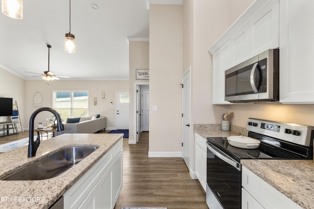 kitchen with white cabinets, stainless steel appliances, crown molding, dark hardwood / wood-style floors, and sink