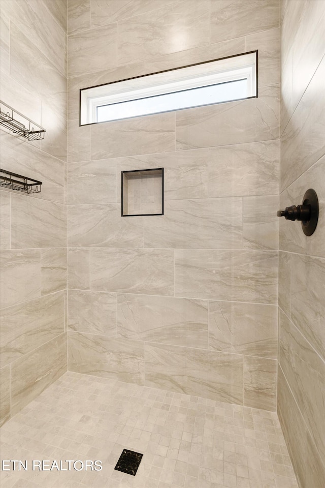 bathroom with a tile shower