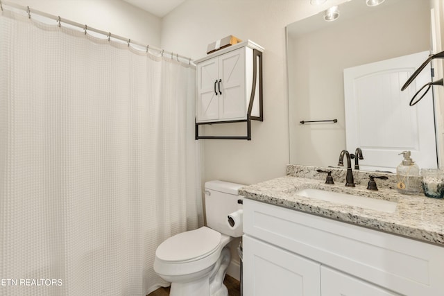 bathroom featuring vanity, toilet, and a shower with curtain