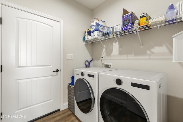 laundry room with dark hardwood / wood-style floors and washer and clothes dryer