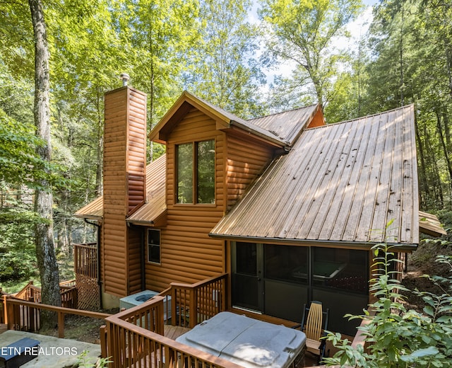 back of property with a wooden deck