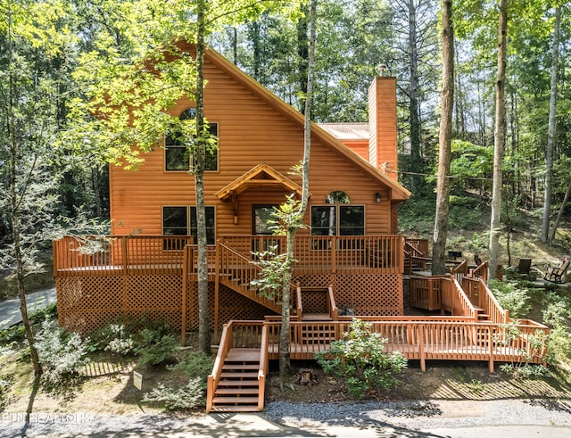 back of property with a wooden deck