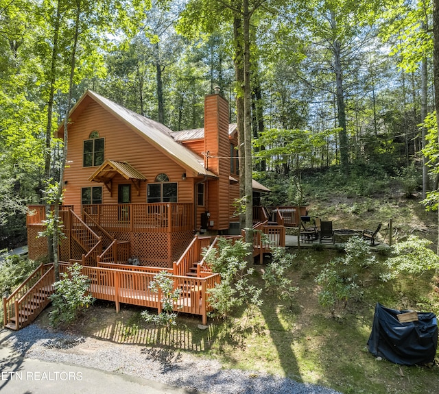 rear view of property featuring a deck