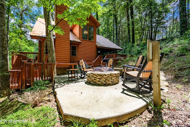 view of patio / terrace with a fire pit and a deck