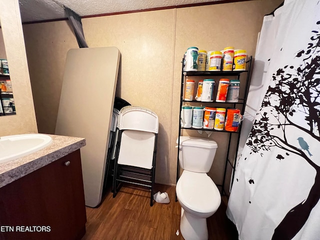 bathroom with vanity, a textured ceiling, toilet, and hardwood / wood-style flooring