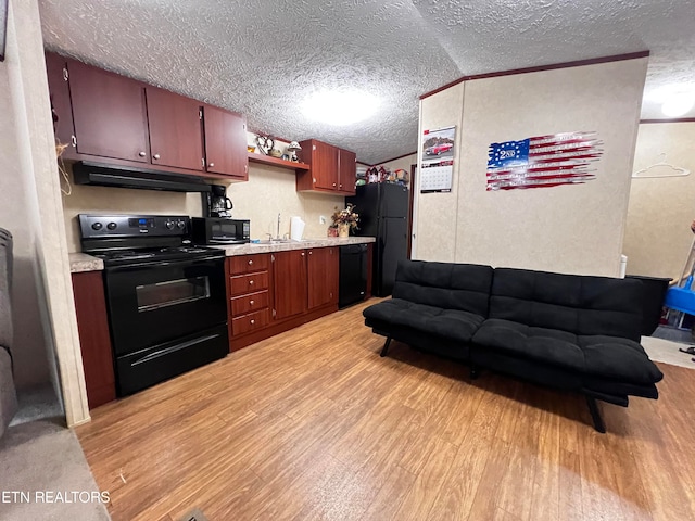 kitchen with a textured ceiling, light wood-type flooring, lofted ceiling, and black appliances