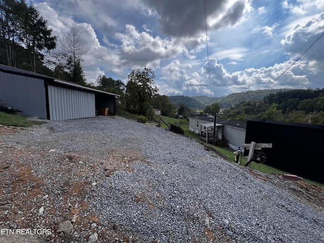 exterior space with a mountain view and an outdoor structure