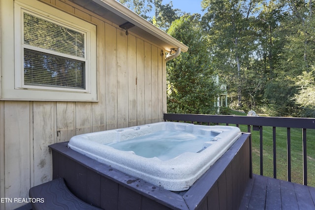 wooden deck with a hot tub