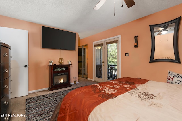 bedroom with carpet flooring, access to exterior, ceiling fan, and a textured ceiling