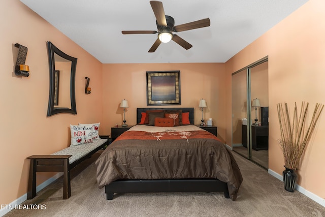 carpeted bedroom with ceiling fan and a closet