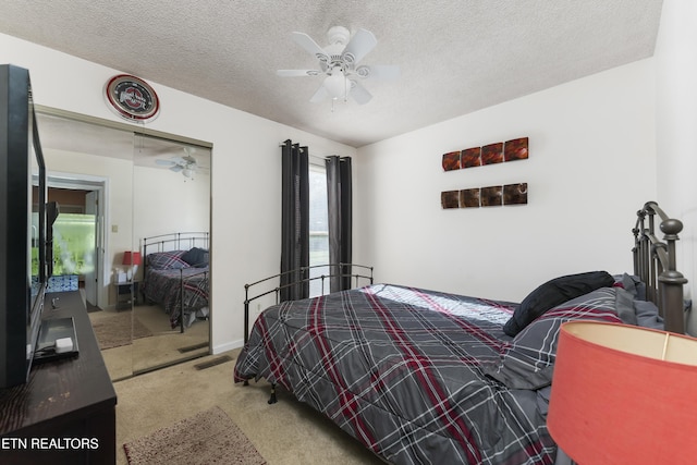 bedroom with carpet flooring, ceiling fan, a textured ceiling, and a closet