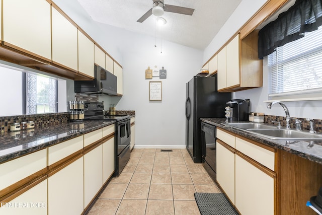 kitchen featuring sink, white cabinets, black appliances, and lofted ceiling