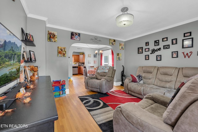 living room with crown molding and hardwood / wood-style flooring