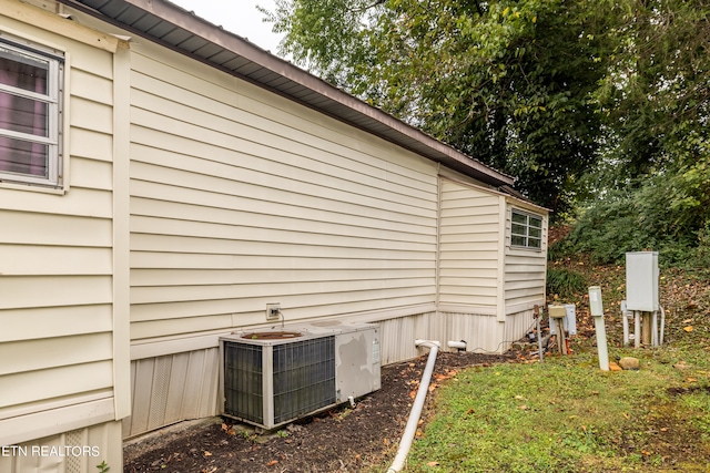 view of side of property featuring central AC unit