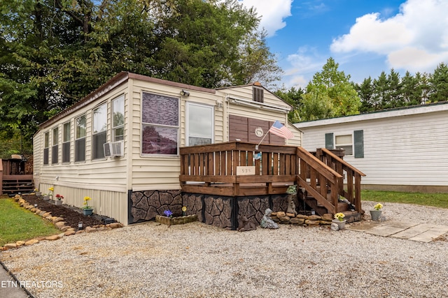 back of house with cooling unit and a deck